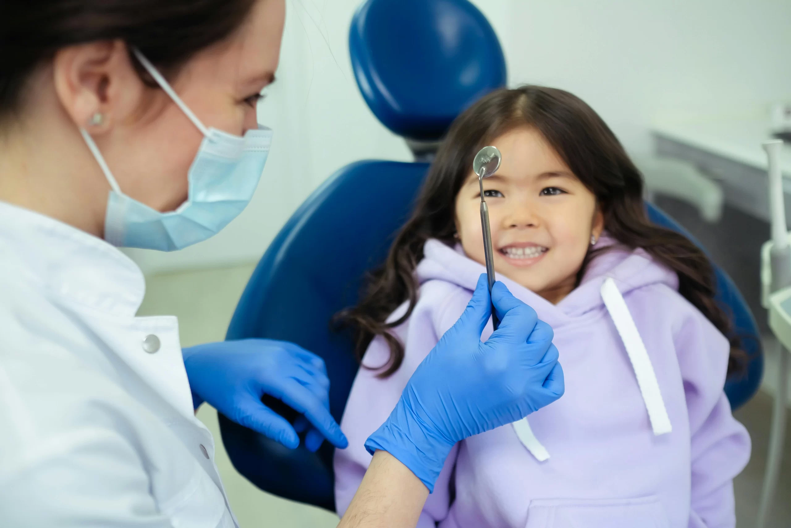 A girl receiving preventive dental care during her routine checkups.