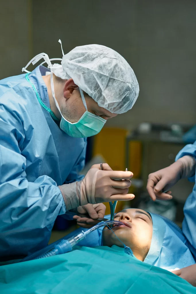 A dentist doing an oral surgery to the patient.