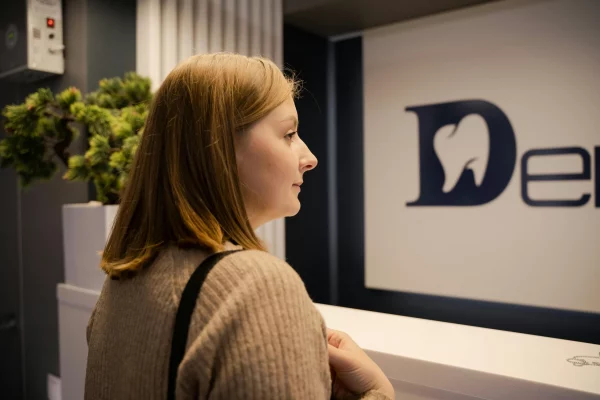 A patient's sign of relief knowing her dental sessions are covered by her dental insurance.