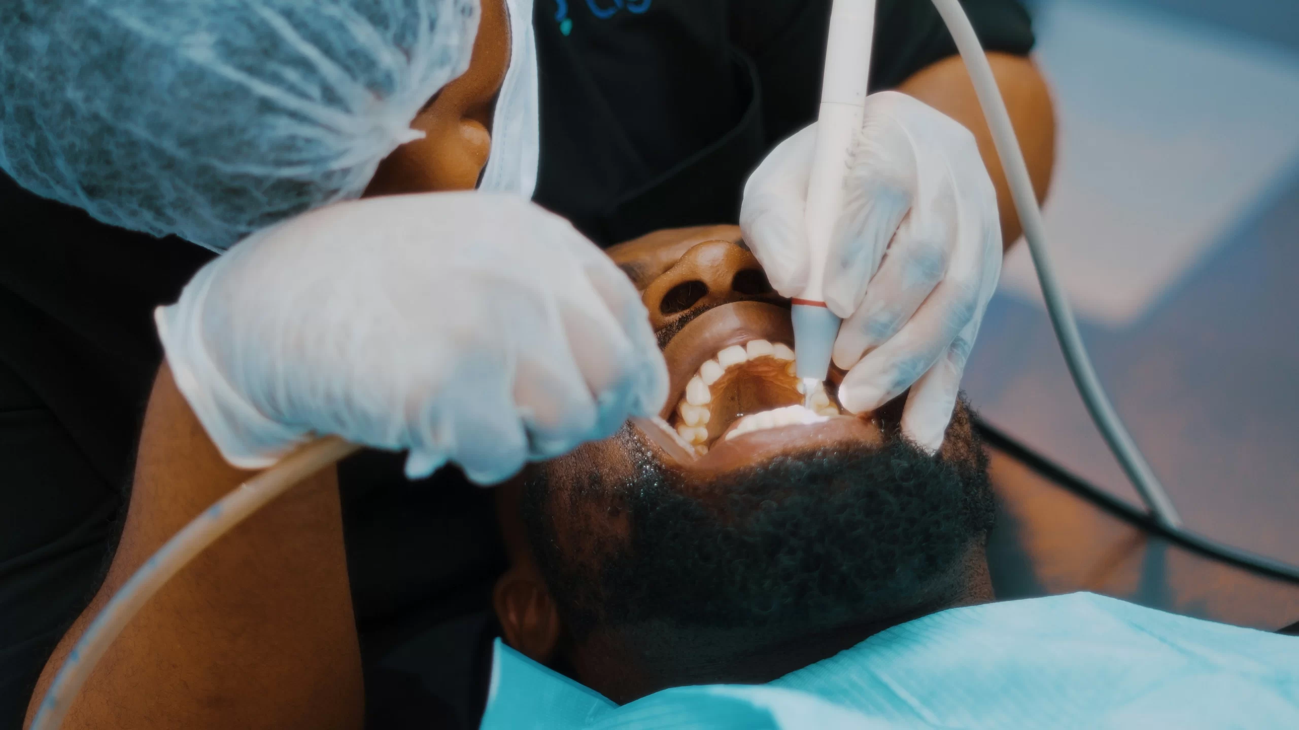 A man getting his teeth whitening treatment in the clinic.