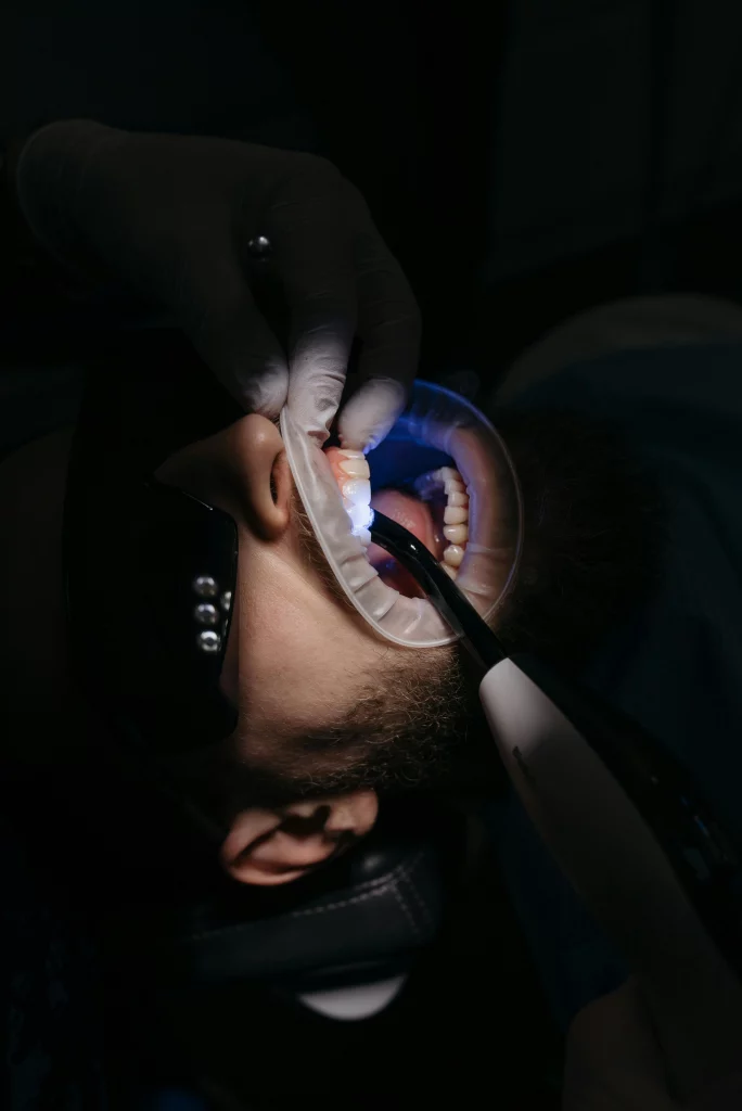 The doctor inspects the patient's cavities. 